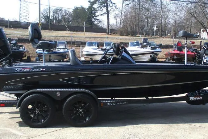 Slide: The Image of 2025 Triton 20XP boat with sleek black design on a trailer. - 3
