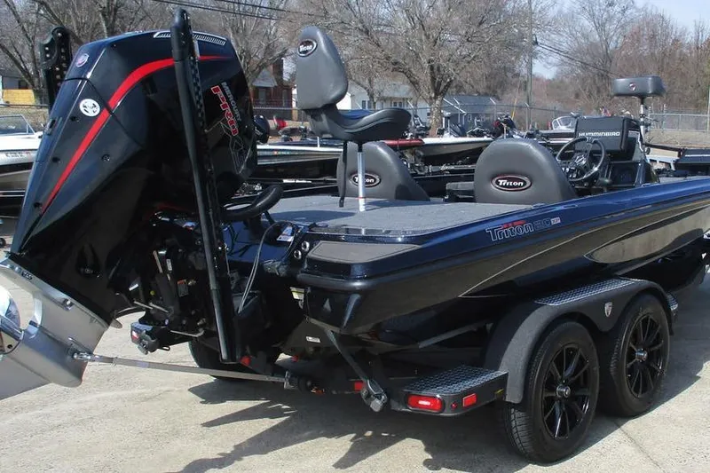 Slide: The Image of 2025 Triton 20XP boat with powerful engine and sleek design on a trailer. - 4