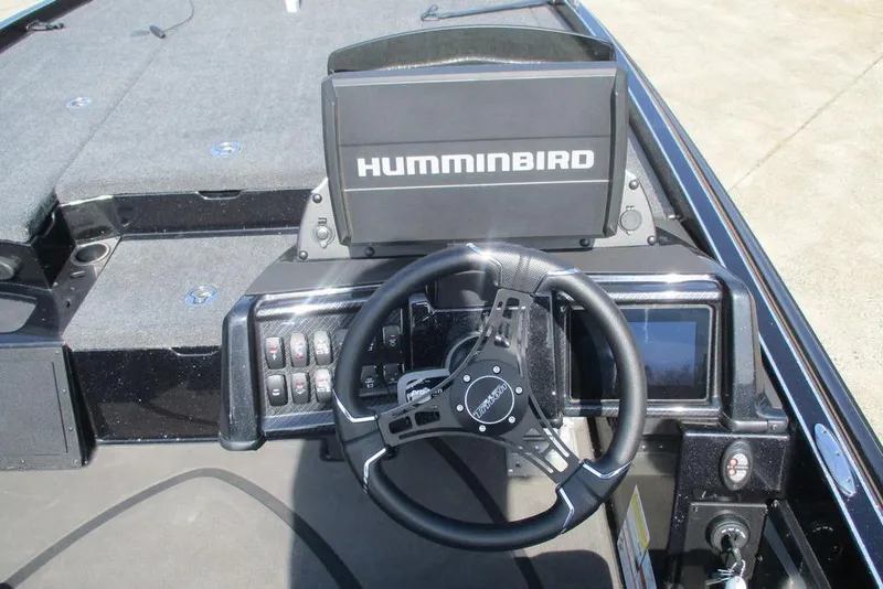 Slide: The Image of Cockpit of 2025 Triton 20XP boat with Humminbird navigation system and steering wheel. - 6