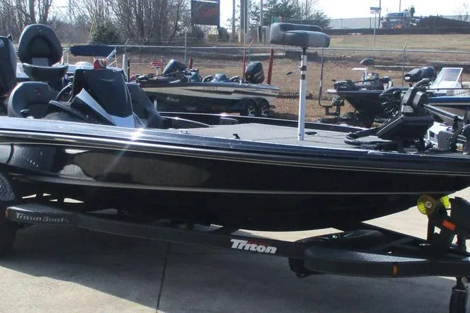 Slide: The Image of 2025 Triton 20XP boat on trailer, parked outdoors, showcasing sleek design and modern features. - 7