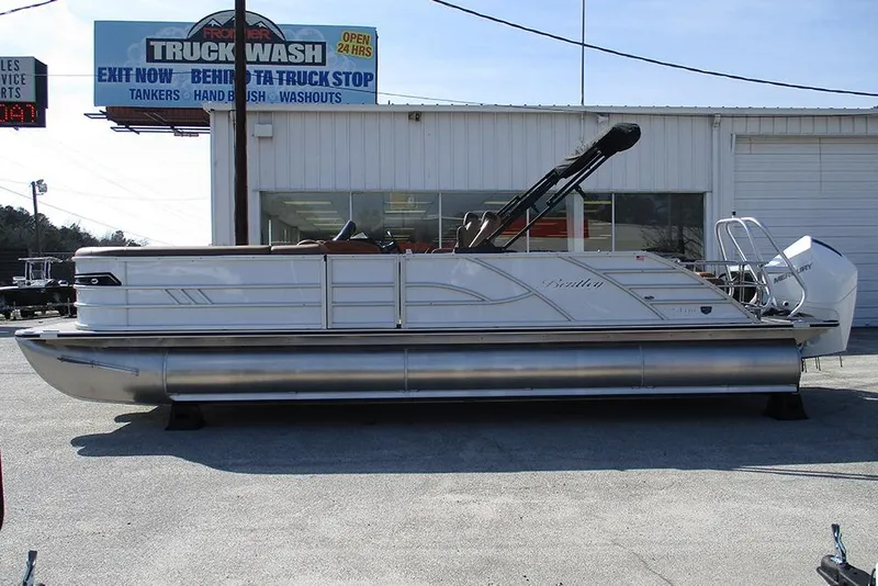 The Image of 2026 Bentley Pontoons Elite 253 Swingback Dual Captain Full Tritoon displayed outdoors. - 1