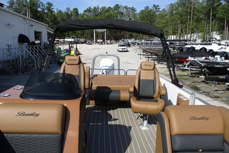 Slide: The Image of 2026 Bentley Pontoons Elite 253 Swingback Dual Captain Full Tritoon with luxurious seating and sleek design. - 10