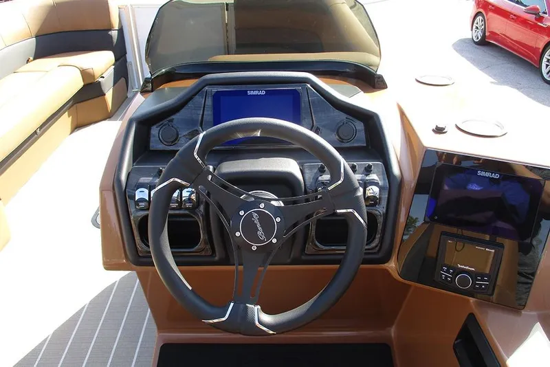 Slide: The Image of 2026 Bentley Pontoons Elite 253 Swingback dashboard with steering wheel and navigation display. - 22