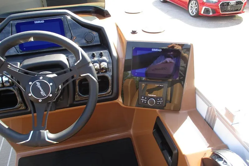 Slide: The Image of 2026 Bentley Pontoons Elite 253 dashboard with steering wheel and Simrad displays. - 23