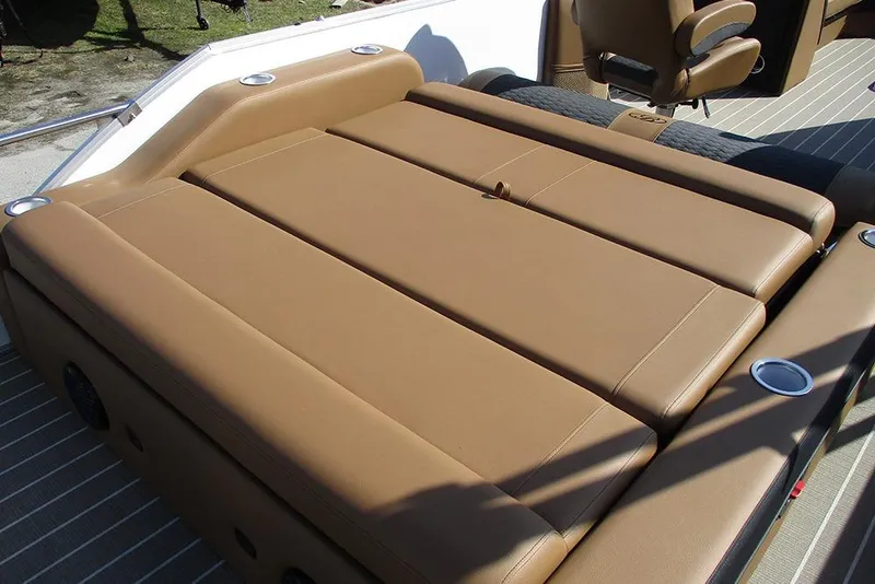Slide: The Image of 2026 Bentley Pontoons Elite 253 Swingback interior with tan leather seating and cup holders. - 24