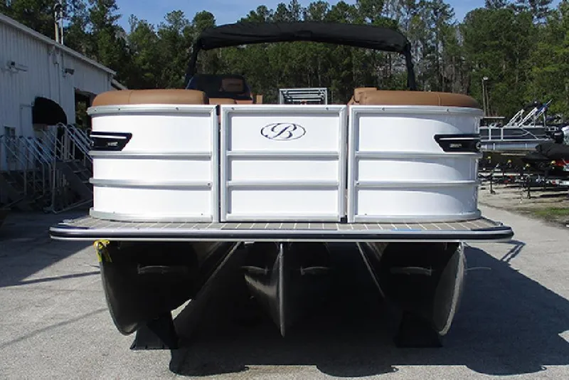 Slide: The Image of 2026 Bentley Pontoons Elite 253 Swingback Dual Captain Full Tritoon, rear view, parked outdoors. - 4
