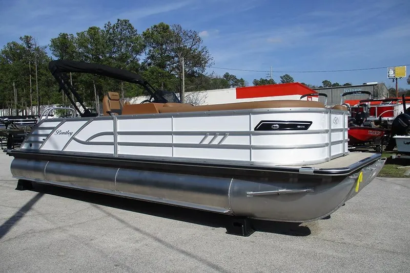 Slide: The Image of 2026 Bentley Pontoons Elite 253 Swingback Dual Captain Full Tritoon, silver, parked outdoors. - 5