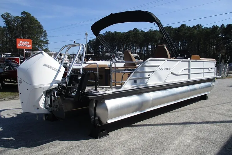Slide: The Image of 2026 Bentley Pontoons Elite 253 Swingback Dual Captain Full Tritoon with Mercury engine, parked outdoors. - 7