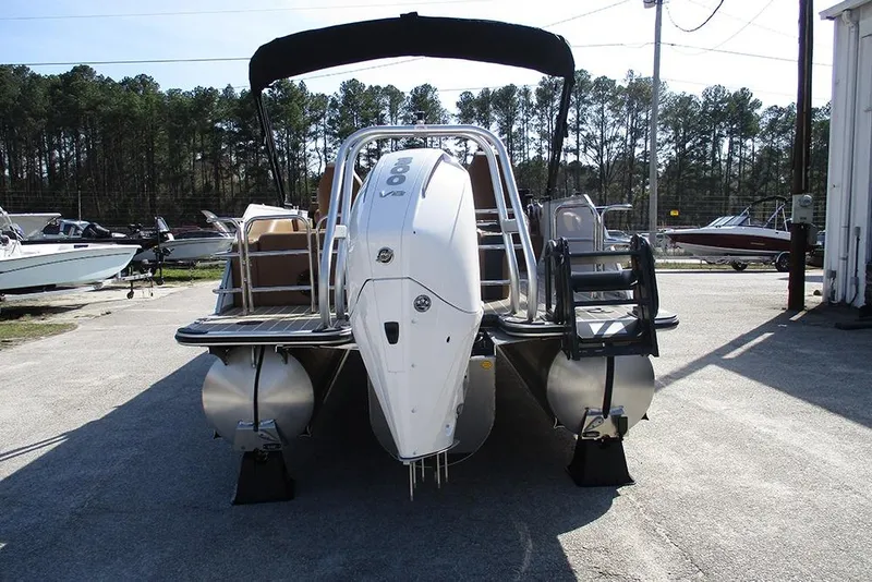 Slide: The Image of 2026 Bentley Pontoons Elite 253 Swingback Dual Captain Full Tritoon, rear view in outdoor setting. - 8