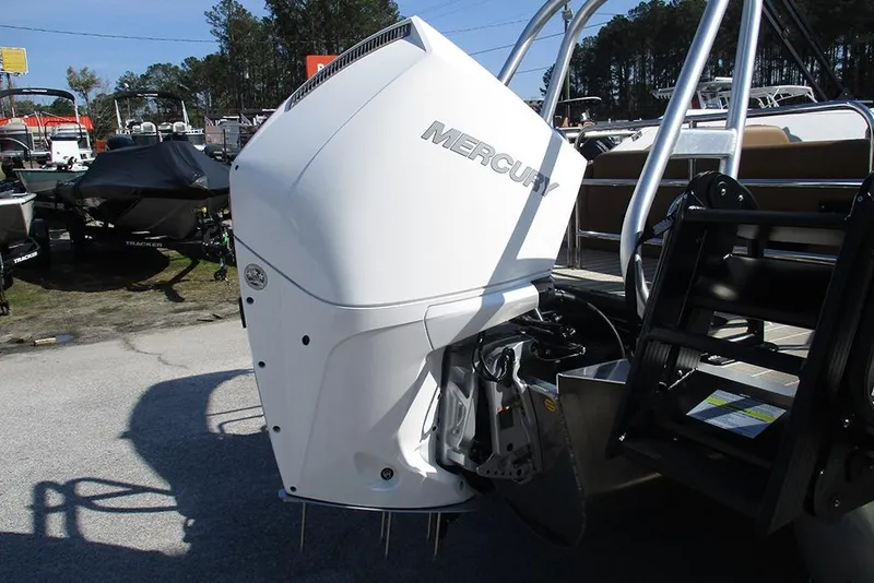 Slide: The Image of 2026 Bentley Pontoons Elite 253 Tritoon with Mercury outboard engine, displayed outdoors. - 9
