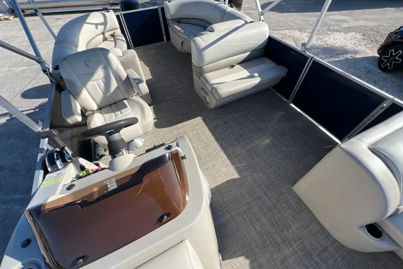 Slide: The Image of 2023 Cypress Cay Seabreeze 232 pontoon boat interior with beige seating and steering console. - 10