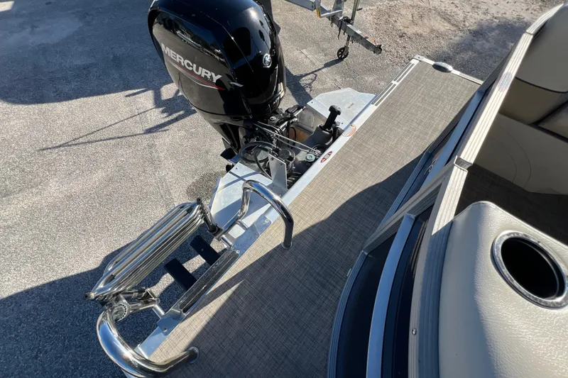 Slide: The Image of 2023 Cypress Cay Seabreeze 232 boat with Mercury outboard motor and swim ladder. - 12