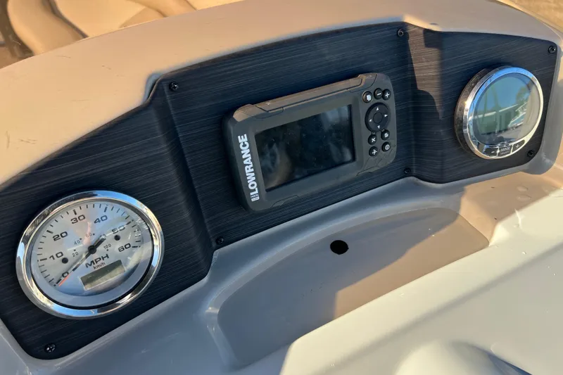 Slide: The Image of Dashboard of 2023 Cypress Cay Seabreeze 232 with speedometer and Lowrance display. - 16