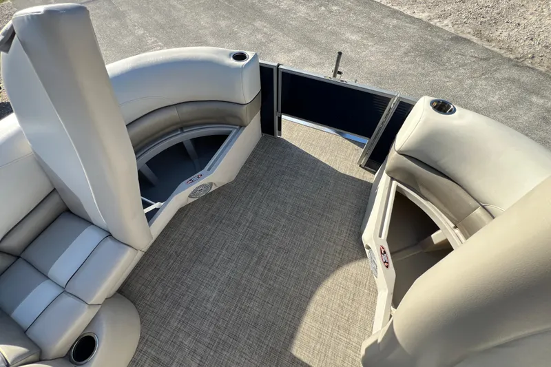 Slide: The Image of 2023 Cypress Cay Seabreeze 232 boat interior with plush seating and open deck area. - 17