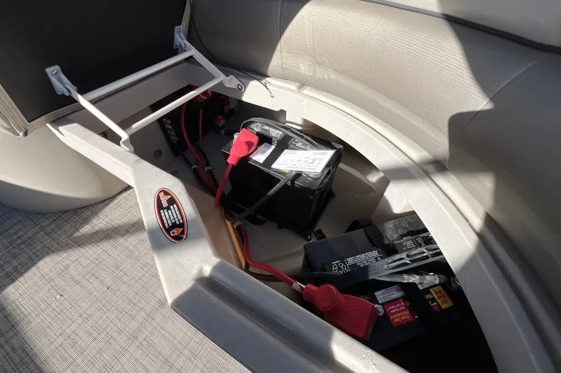 Slide: The Image of Battery compartment of 2023 Cypress Cay Seabreeze 232 pontoon boat, showing wiring and connections. - 19