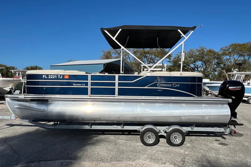 Slide: The Image of 2023 Cypress Cay Seabreeze 232 pontoon boat on trailer, under clear blue sky. - 5