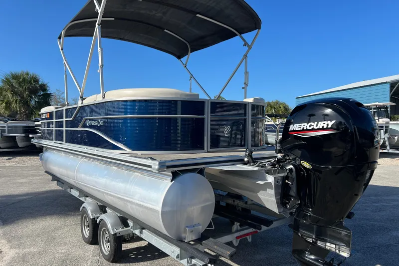 Slide: The Image of 2023 Cypress Cay Seabreeze 232 pontoon boat with Mercury outboard motor on trailer. - 6