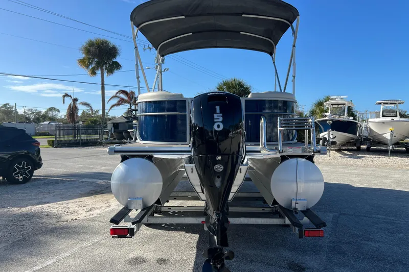 Slide: The Image of 2023 Cypress Cay Seabreeze 232 pontoon boat with Mercury 150 engine, parked outdoors. - 7