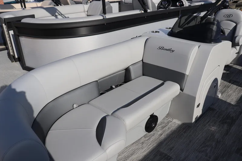 Slide: The Image of 2026 Bentley Pontoons Legacy 220 Navigator with luxurious seating and sleek design. - 2