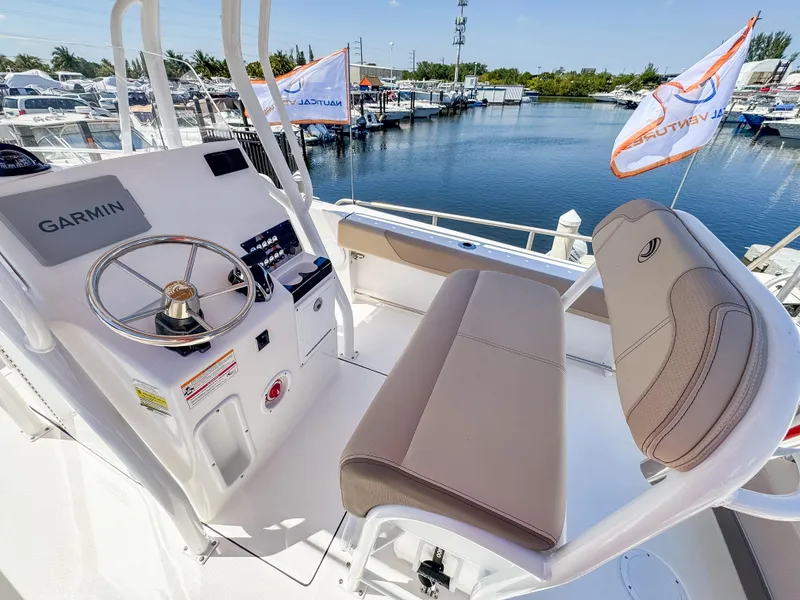 Slide: The Image of Edgewater 208CC 2025 boat helm with Garmin system, docked at marina. - 10