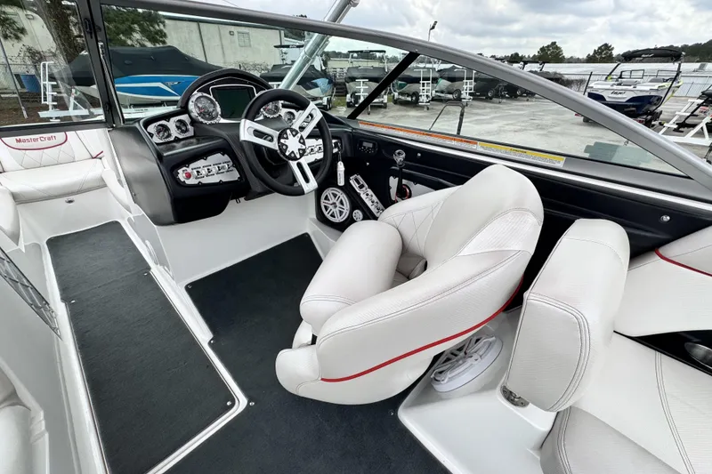 Slide: The Image of 2011 MasterCraft X25 boat interior with white seating and modern dashboard. - 11