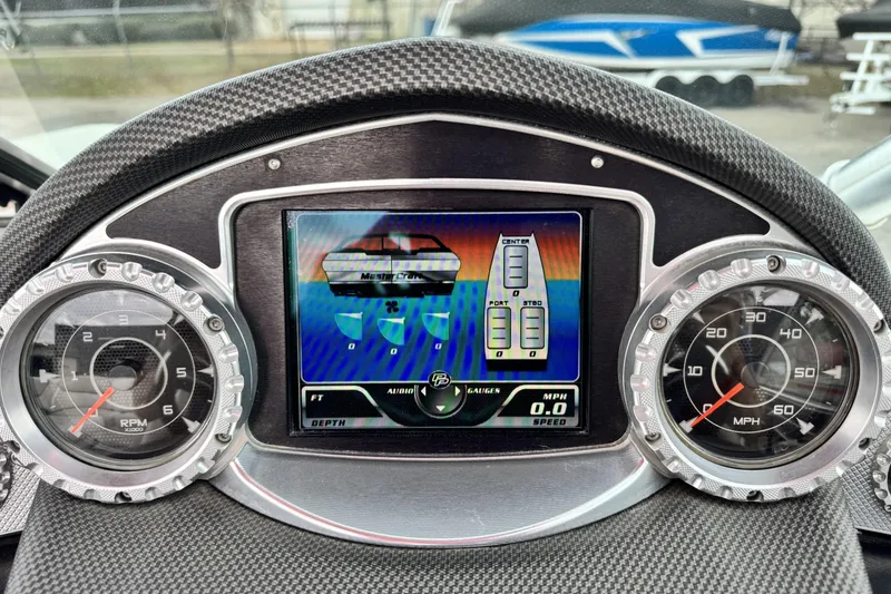 Slide: The Image of Dashboard of a 2011 MasterCraft X25 boat with digital and analog gauges. - 12