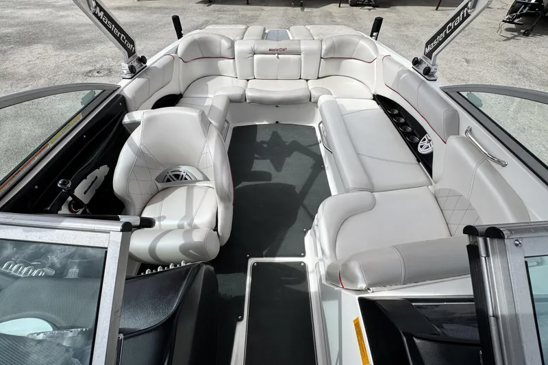 Slide: The Image of 2011 MasterCraft X25 boat interior with white seating and modern design. - 17