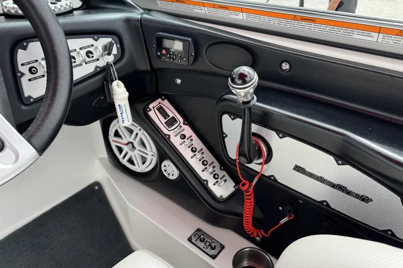 Slide: The Image of 2011 MasterCraft X25 boat dashboard with controls and steering wheel. - 18