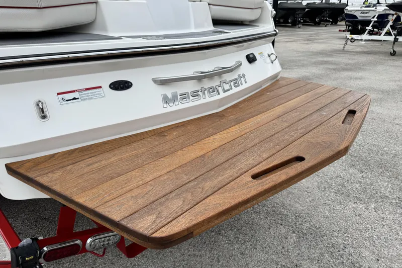 Slide: The Image of 2011 MasterCraft X25 boat with wooden swim platform, rear view. - 6