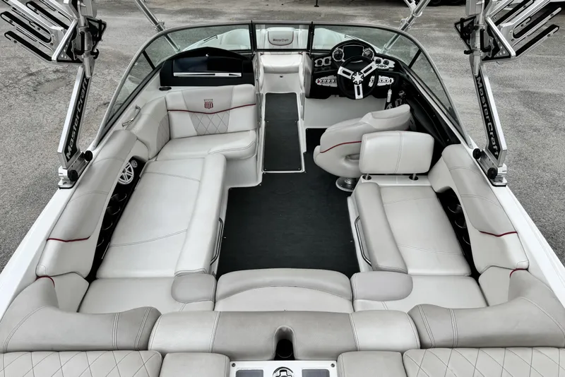 Slide: The Image of 2011 MasterCraft X25 boat interior with luxurious white seating and modern dashboard. - 9
