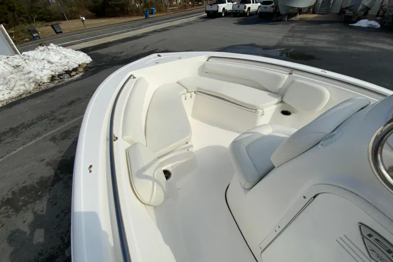 Slide: The Image of 2017 Tidewater 198 CC Adventure boat interior with white seating and console. - 17