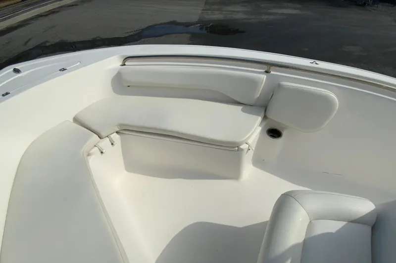 Slide: The Image of 2017 Tidewater 198 CC Adventure boat interior with white cushioned seating. - 18