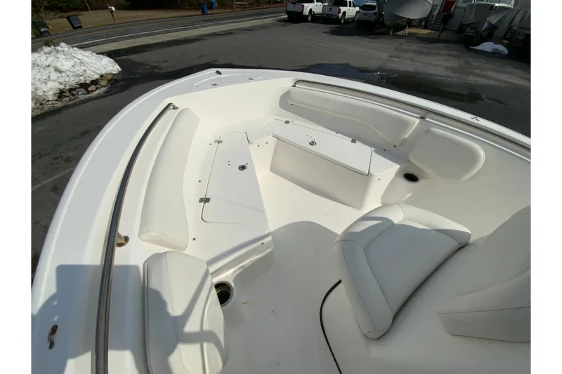 Slide: The Image of 2017 Tidewater 198 CC Adventure boat interior with white seating and storage compartments. - 27