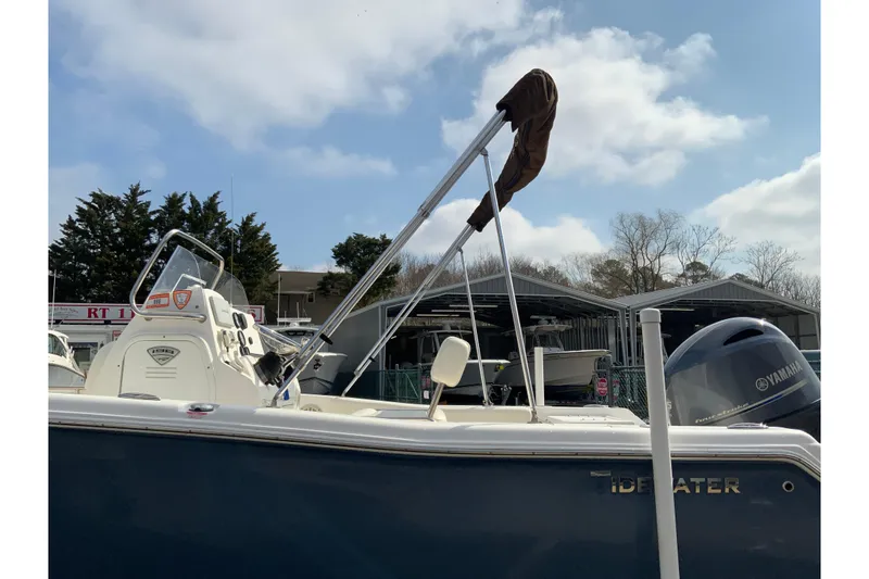 Slide: The Image of 2017 Tidewater 198 CC Adventure boat with Yamaha engine, parked outdoors under a cloudy sky. - 30