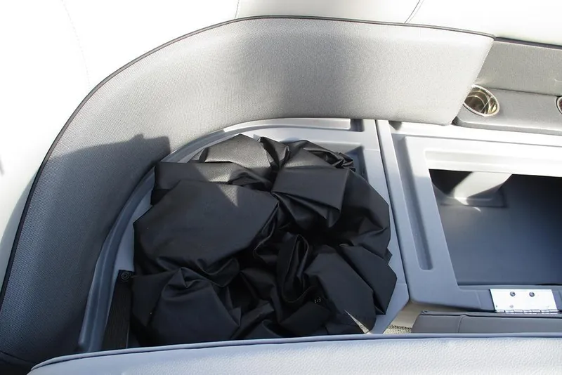 Slide: The Image of 2026 Bentley Pontoons Legacy 243 DL Navigator interior storage compartment with black cover. - 17