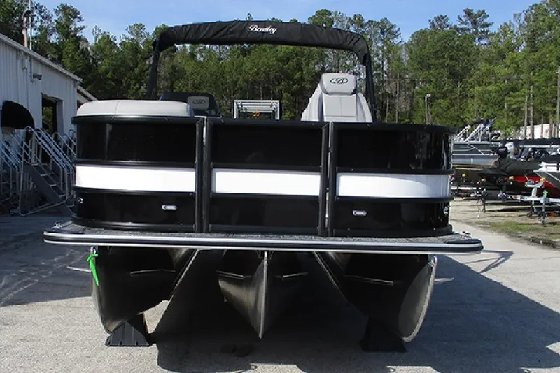 Slide: The Image of 2026 Bentley Pontoons Legacy 243 DL Navigator, black and white, parked outdoors. - 4