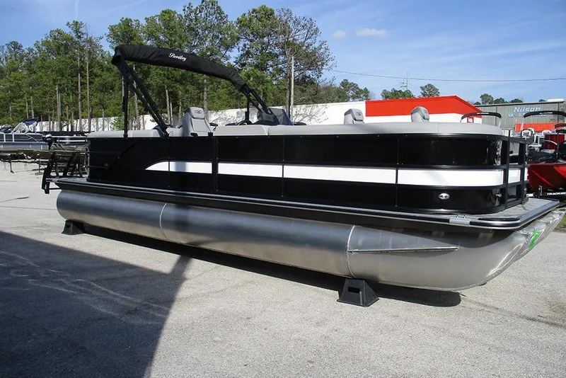 Slide: The Image of 2026 Bentley Pontoons Legacy 243 DL Navigator, sleek black and white design, parked outdoors. - 5