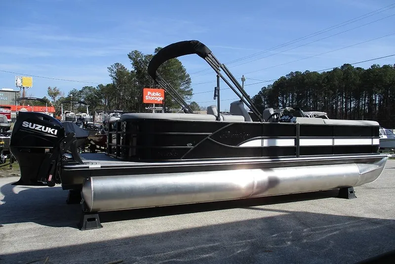 Slide: The Image of 2026 Bentley Pontoons Legacy 243 DL Navigator with Suzuki engine, parked outdoors. - 6