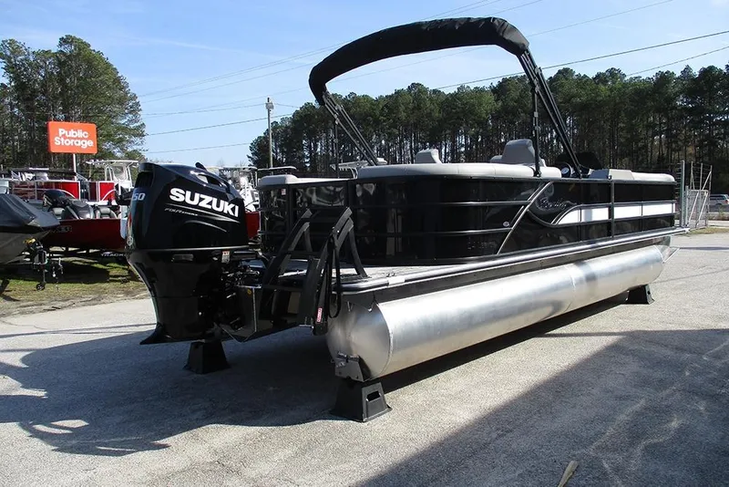 Slide: The Image of 2026 Bentley Pontoons Legacy 243 DL Navigator with Suzuki engine, parked outdoors. - 7