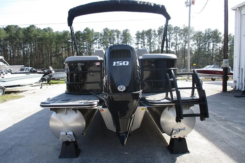 Slide: The Image of 2026 Bentley Pontoons Legacy 243 DL Navigator with powerful outboard motor, docked outdoors. - 8