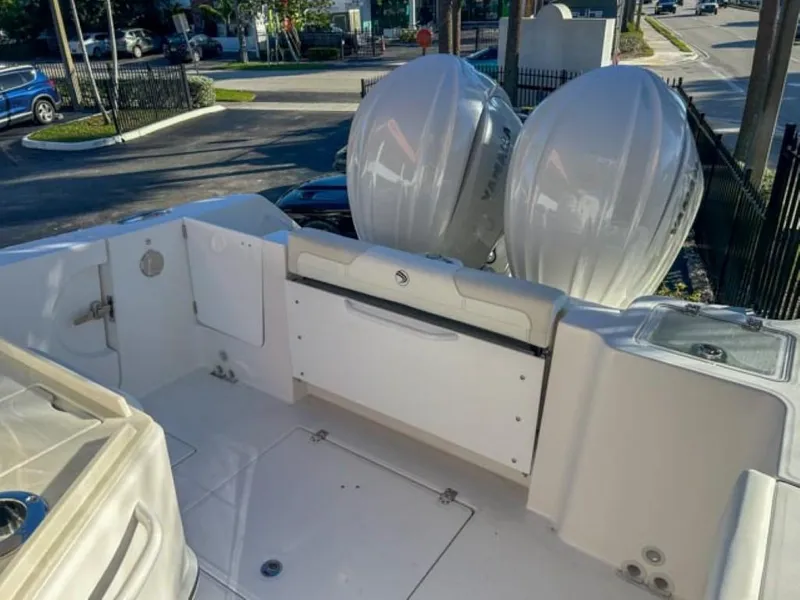 Slide: The Image of 2025 Edgewater 262CC boat deck with dual outboard motors. - 21