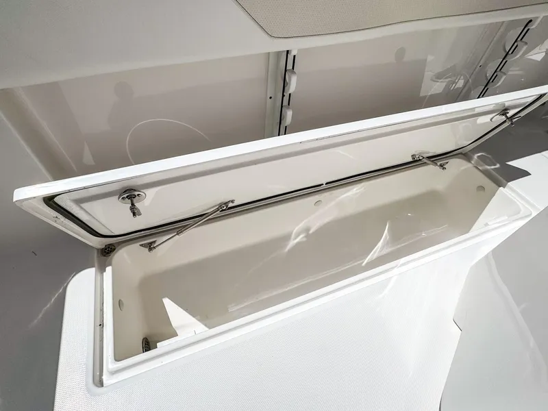 Slide: The Image of Open storage compartment on 2025 Edgewater 262CC boat, showcasing spacious interior design. - 24