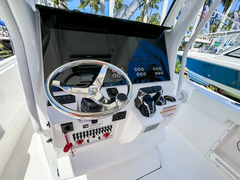 Slide: The Image of 2025 Edgewater 262CC boat dashboard with steering wheel and control panel. - 5