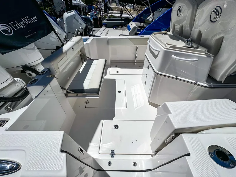 Slide: The Image of 2025 Edgewater 262CC boat interior with seating and storage compartments. - 18