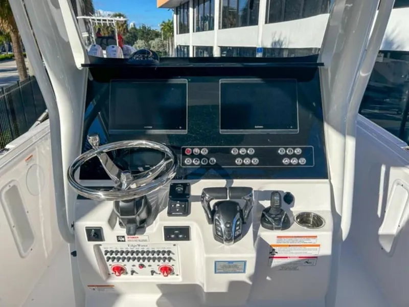 Slide: The Image of 2025 Edgewater 262CC boat dashboard with steering wheel and control panel. - 6