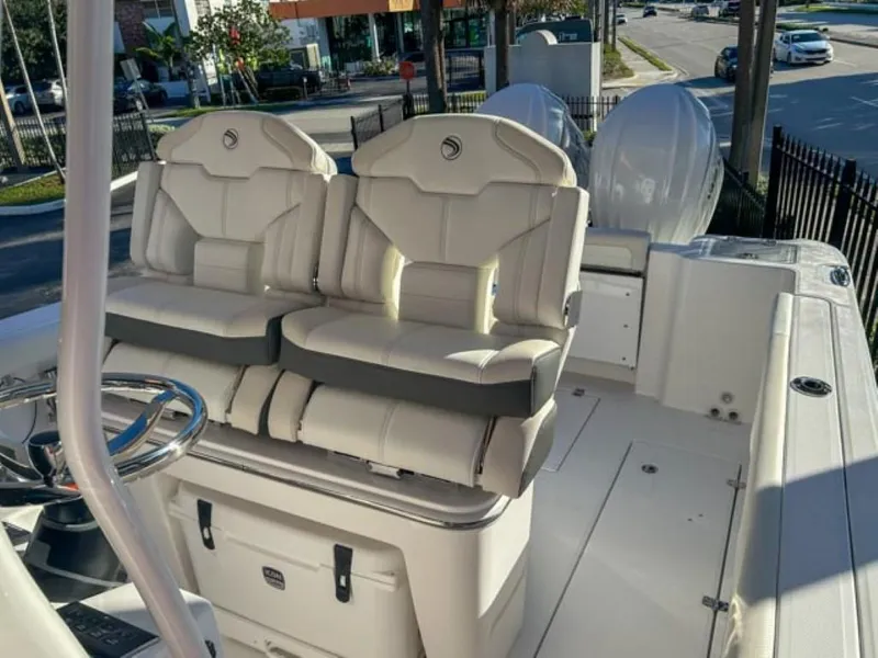 Slide: The Image of 2025 Edgewater 262CC boat interior with dual seats and steering wheel. - 9
