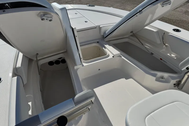 Slide: The Image of 2026 Robalo 246 Cayman boat interior with open storage compartments and seating. - 10
