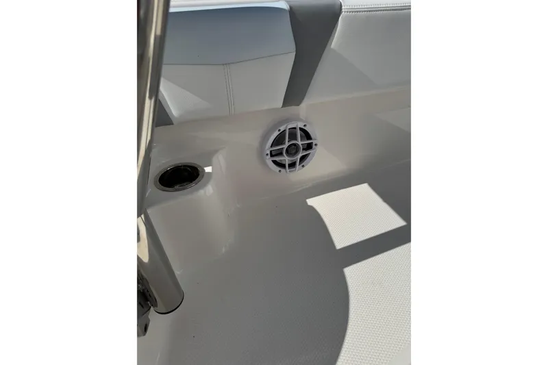 Slide: The Image of 2026 Robalo 246 Cayman boat interior with speaker and cup holder. - 11