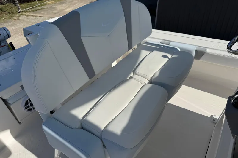 Slide: The Image of 2026 Robalo 246 Cayman boat seat, featuring sleek white and gray upholstery. - 16