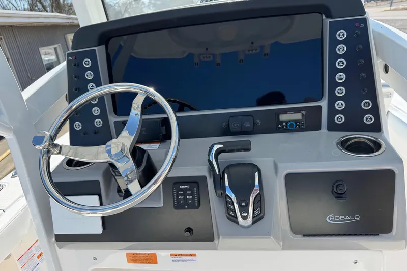 Slide: The Image of 2026 Robalo 246 Cayman boat dashboard with steering wheel and control panel. - 18